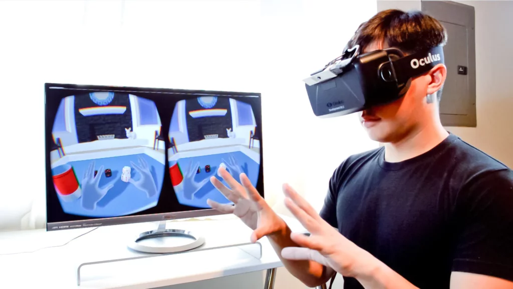 Gamer using vr glasses and controller to play video games. Man with virtual  reality goggles holding joystick in front of computer, playing online game.  Player having fun with games Stock Photo 