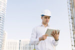 medium-shot-young-man-with-helmet-tablet-scaled